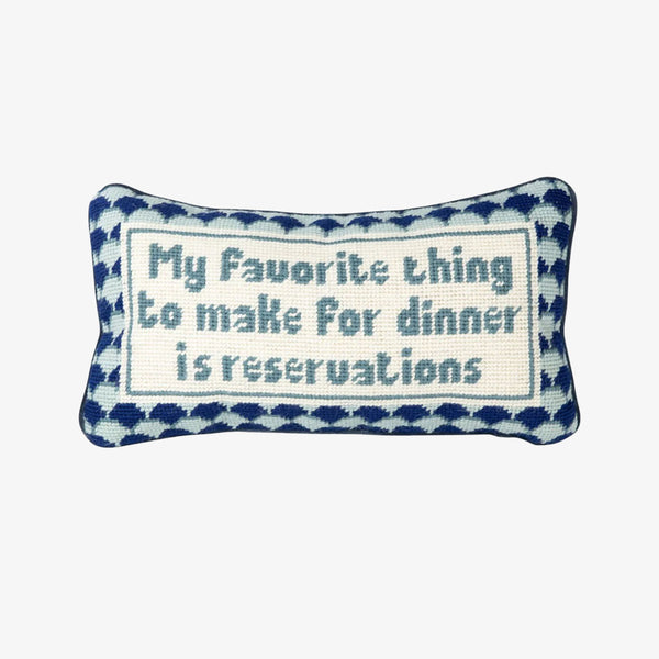 Furbish brand needlepoint pillow with saying 'my favorite thing to make for dinner is reservations' on a white background