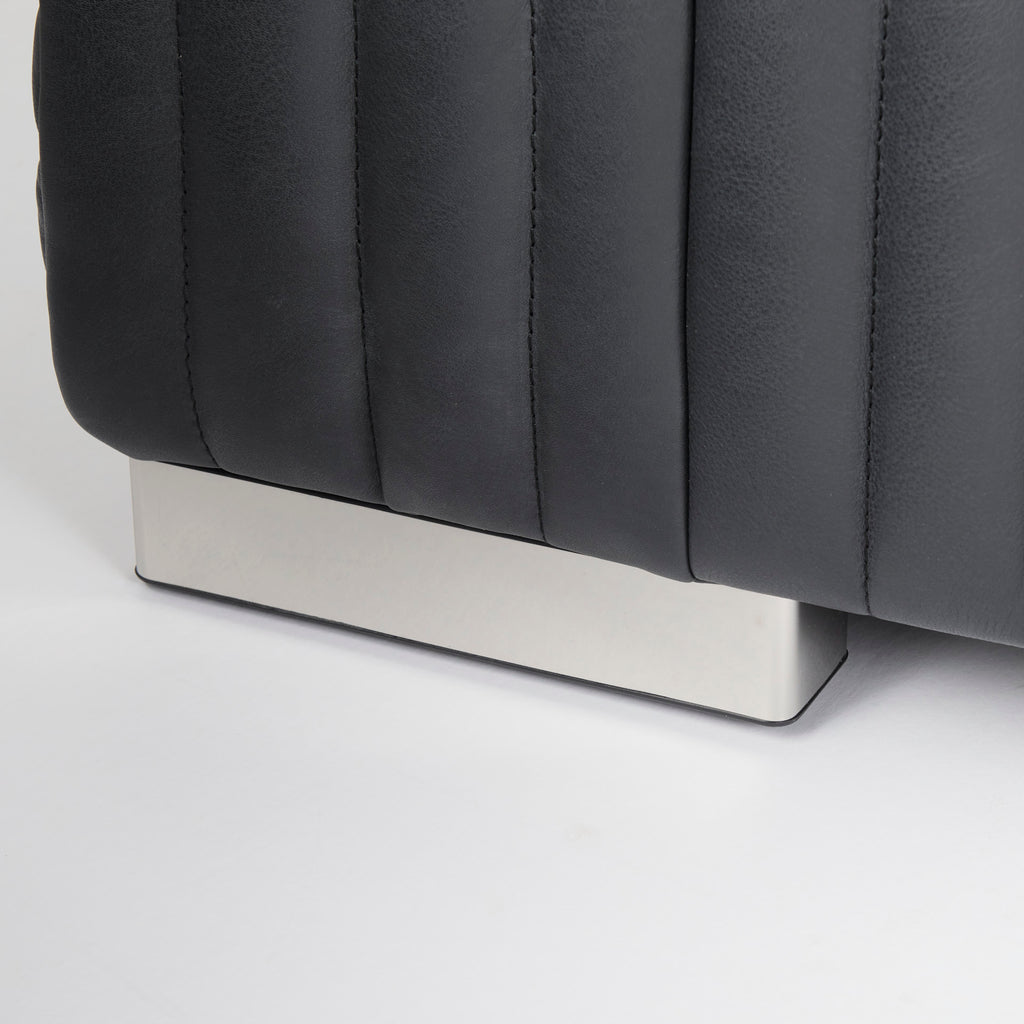Close up of Ricciardo ribbed Black Leather Wrapped Three Seater Sofa on a white background