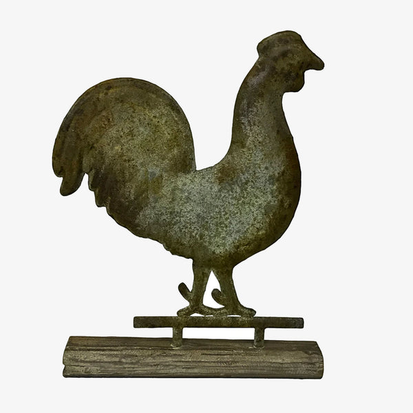 Metal rooster weathervane statue on a sold wood base on a white background