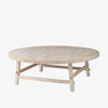 Whitewashed wood round coffee table with square dowel legs and bracing on a white background