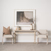 Rosie Small Blonde Wood Console Table in a living room with two chairs and a black and white photograph on the wall