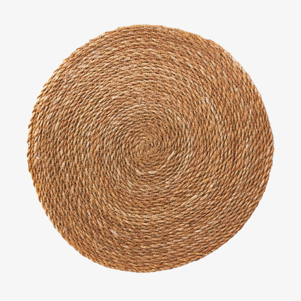 Round natural jute placemat on a white background