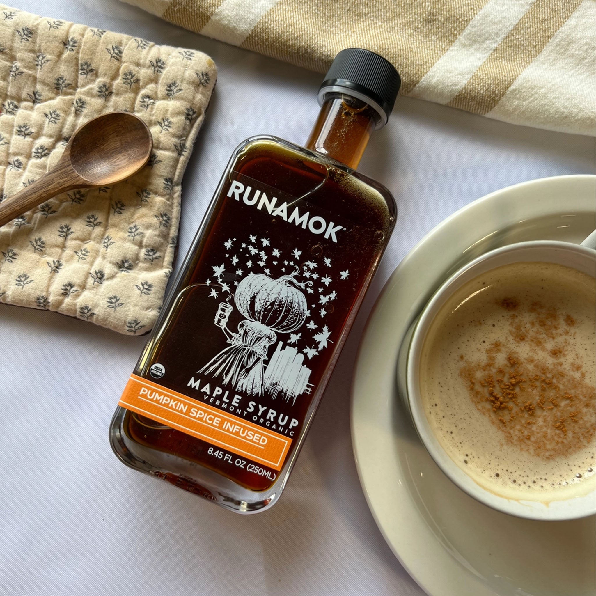 Runamok Pumpkin Spice Infused Organic Maple Syrup on a white table at Addison West