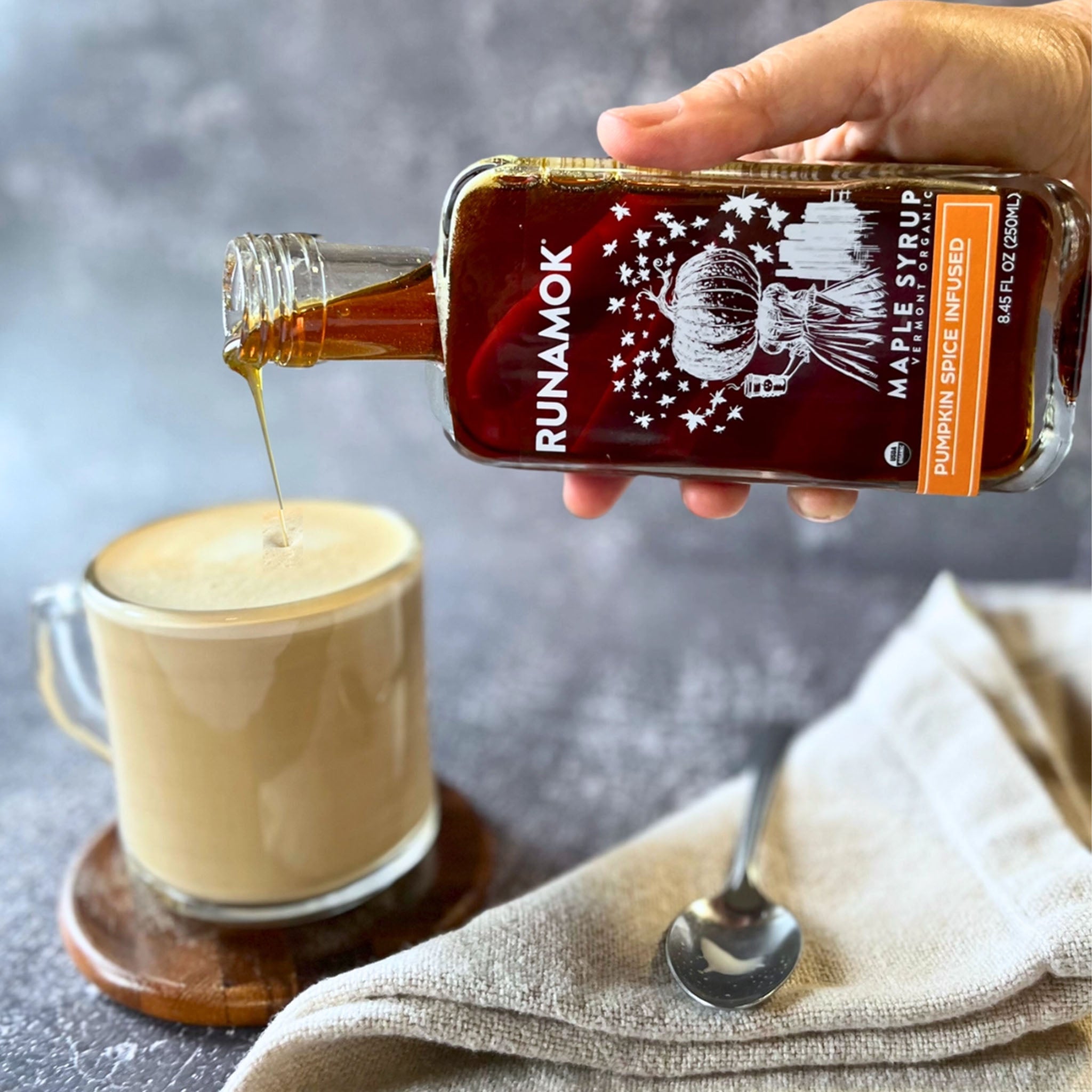 Runamok Pumpkin Spice Infused Organic Maple Syrup on a grey background at Addison West