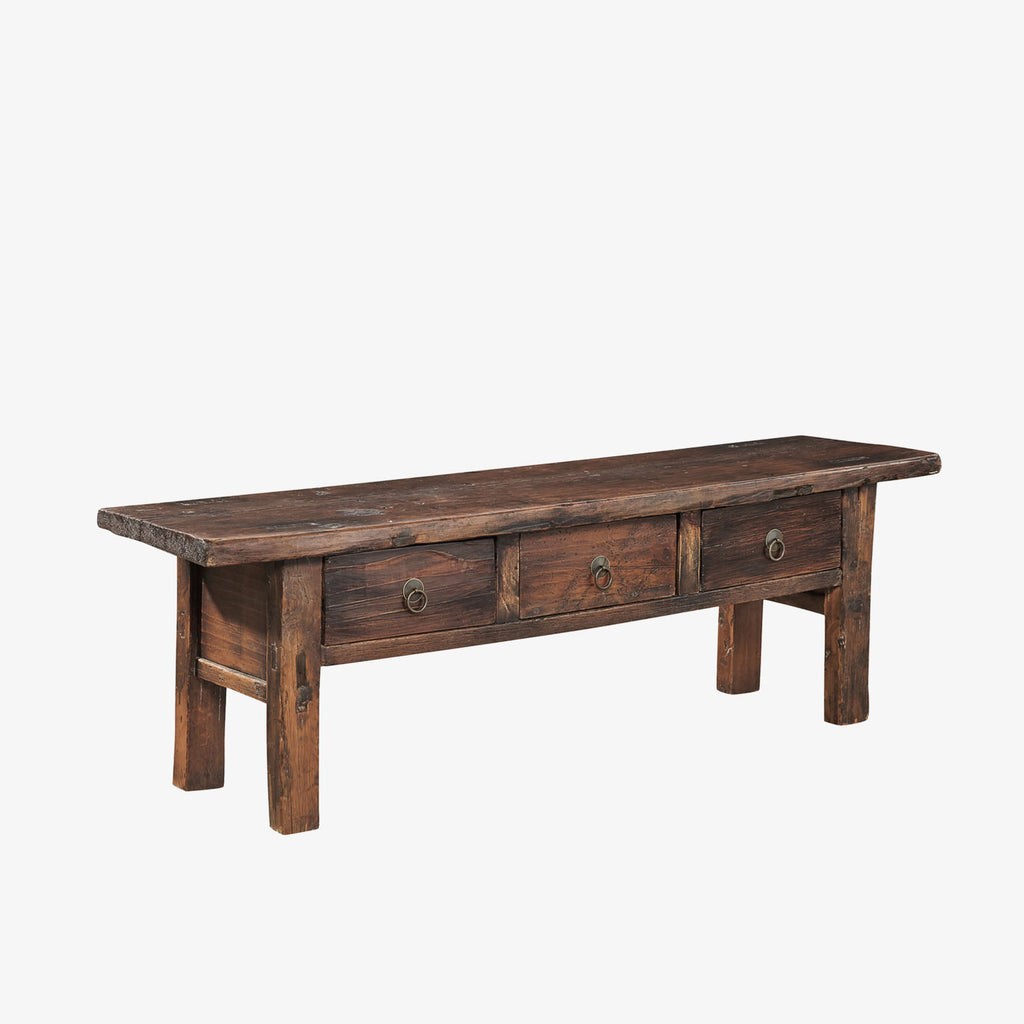 Rustic wood coffee table by furniture classics brand with three drawers on a white background