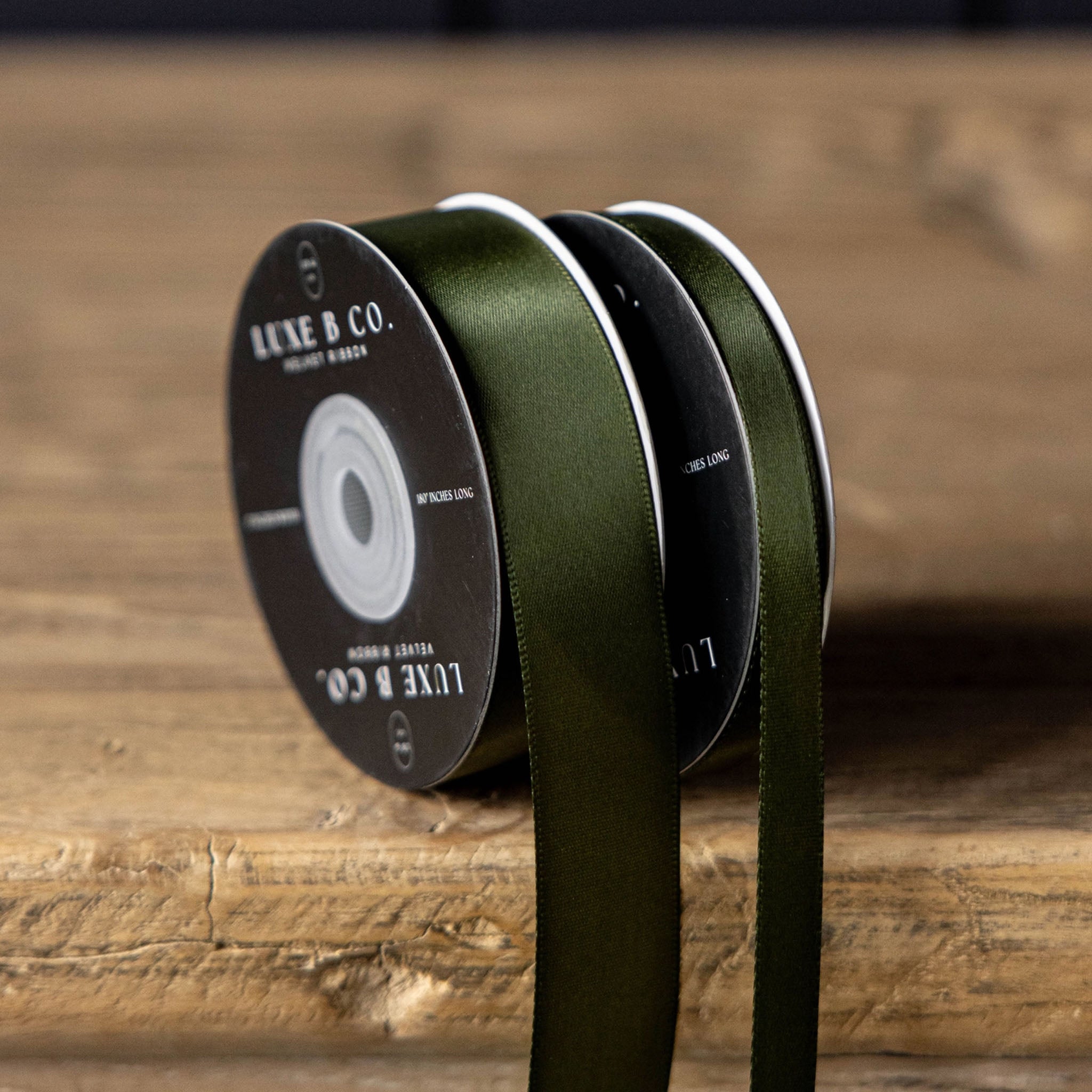 Satin Ribbon in Forest Green, Small on a wood table at Addison West