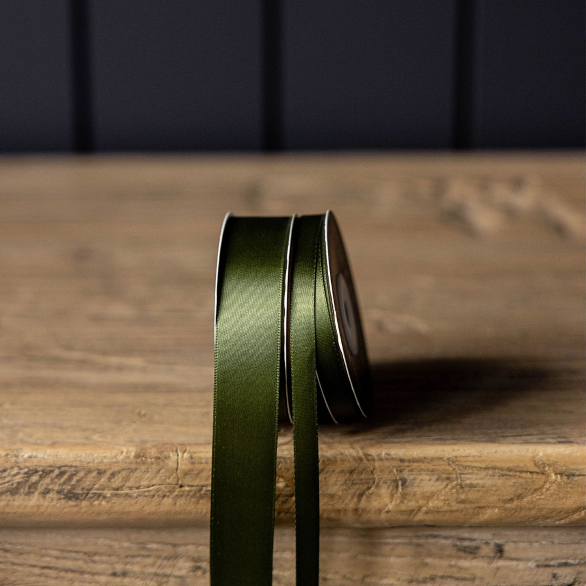 Satin Ribbon in Forest Green, Small on a wood table at Addison West