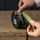 Satin Ribbon in Forest Green, Medium on a wood table at Addison West