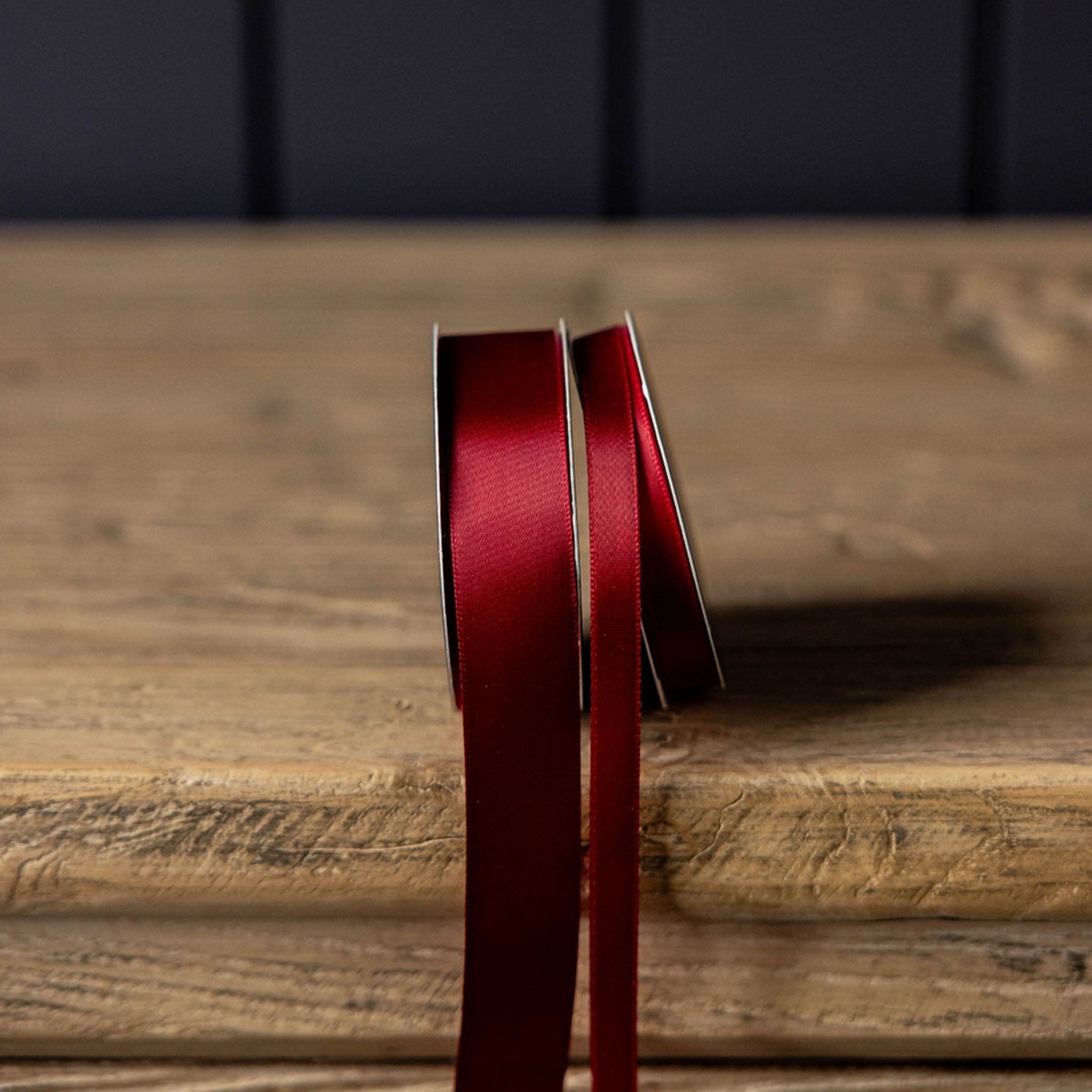 Satin Ribbon in Red, Small on a wood table at Addison West