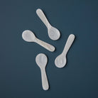 Mini Mother of Pearl Spoon on a blue background at Addison West