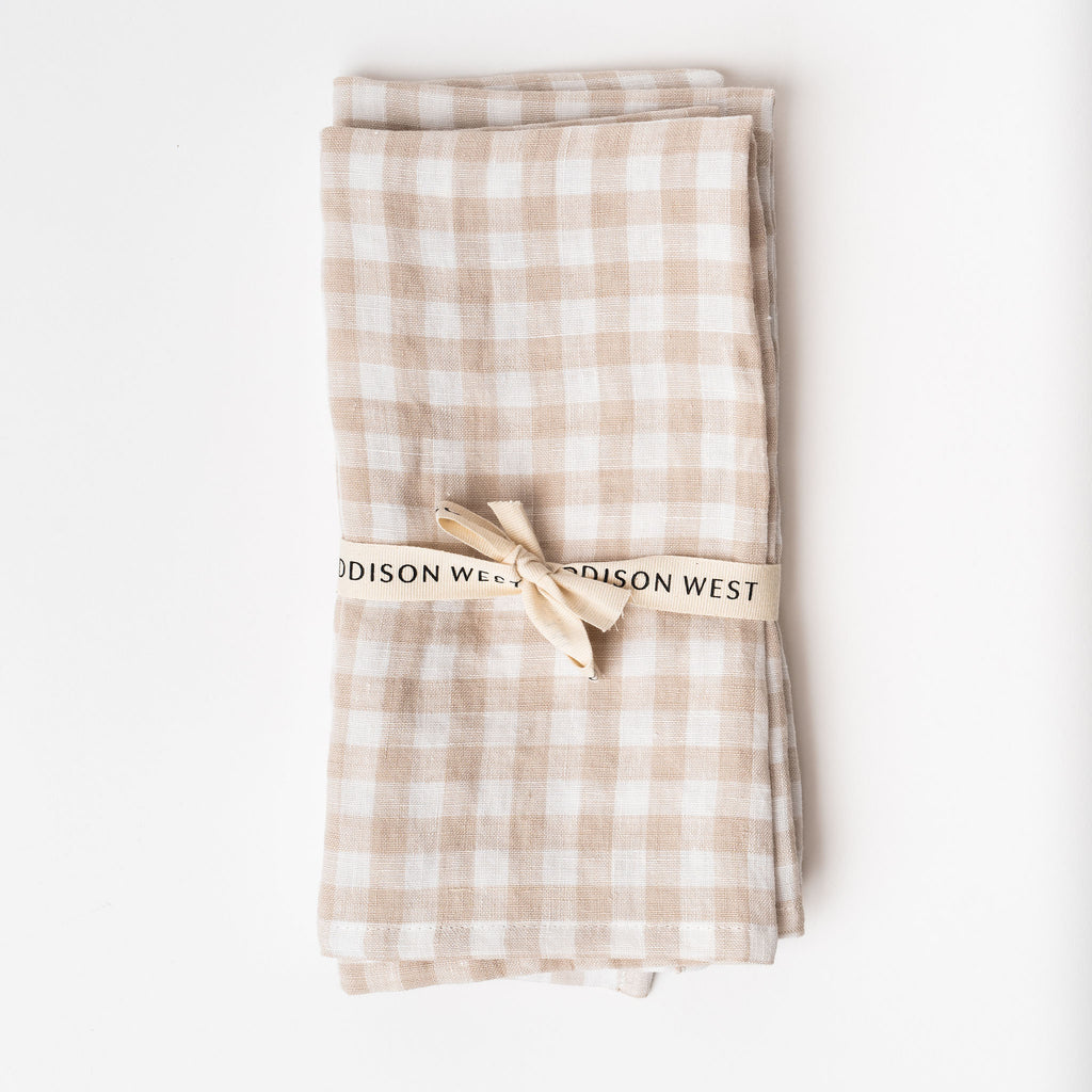 Set of two linen napkins in beige gingham on a white background
