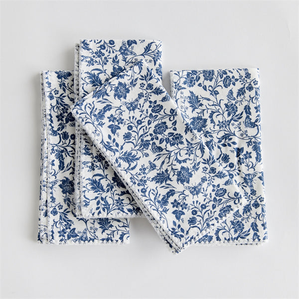 Blue and white floral cotton napkins with hemstitch edges on a white background