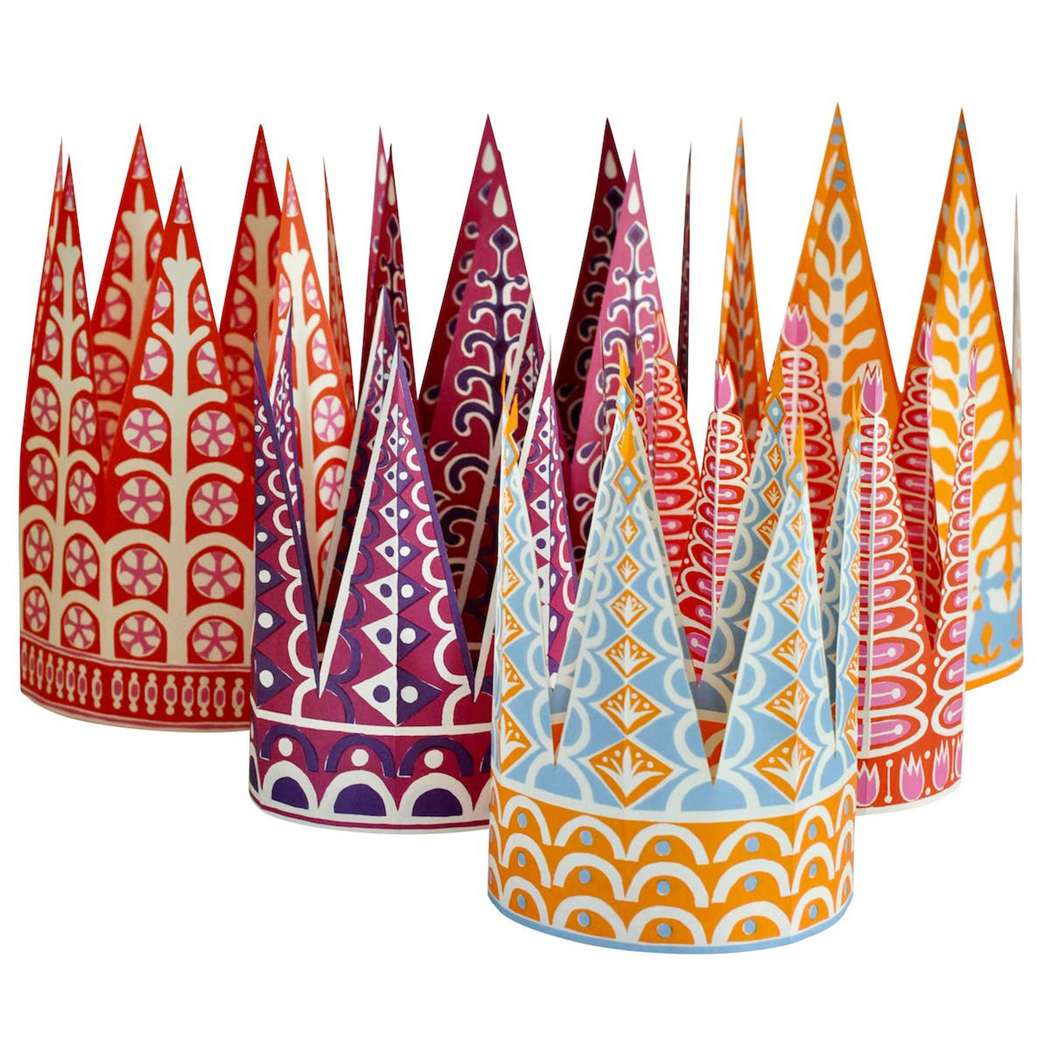 Colorful paper crowns with geometric patterns on a white background