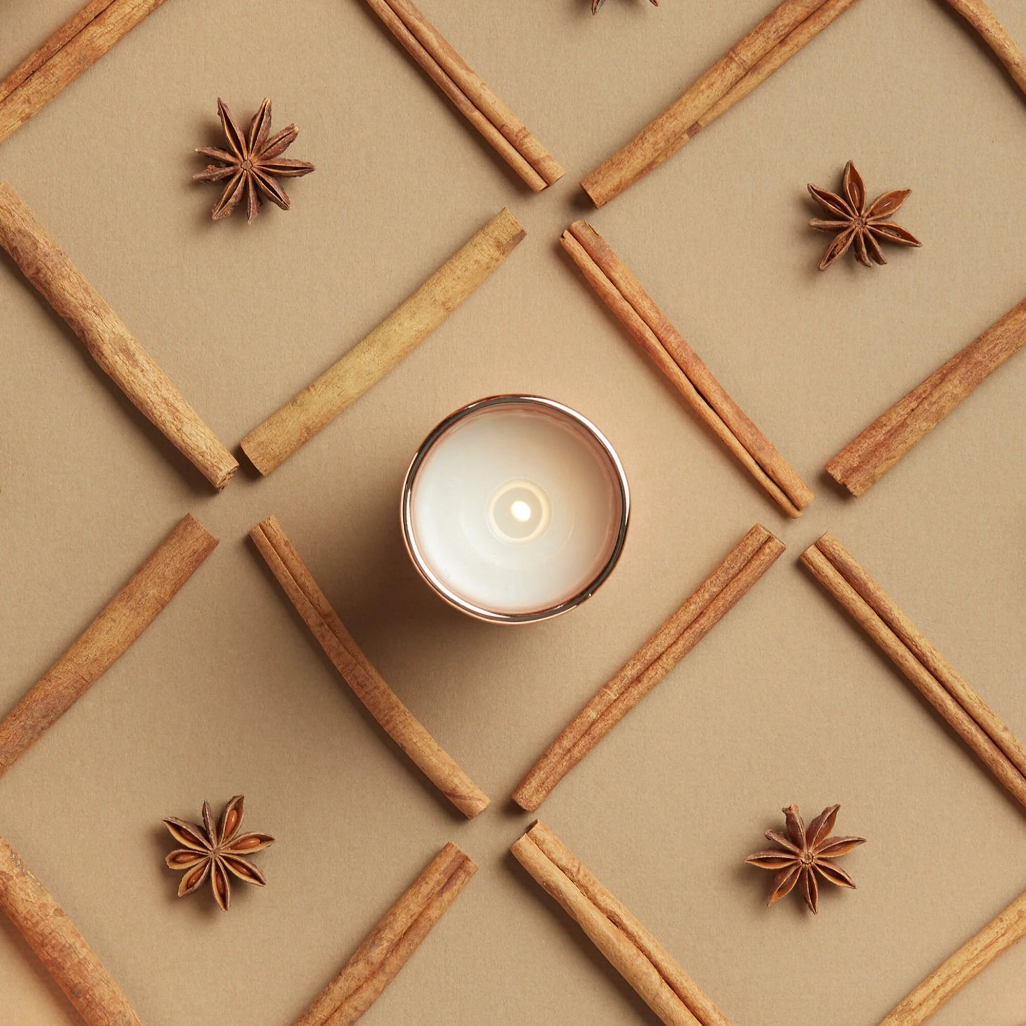 Thymes Simmered Cider Votive Candle on a beige background at Addison West
