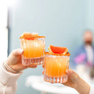 Simon Pearce Montpelier Double Old Fashioned, Set of 2 held by models at Addison West