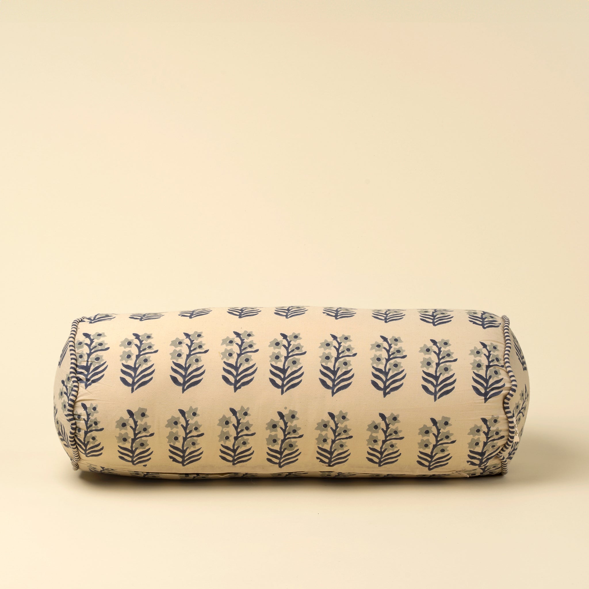 Sita Block Print Bolster on a beige background at Addison West