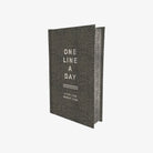 Gray memory book titled 'One Line a Day' on a white background