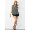 Blond model wearing THML Sleeveless Pleated Top in Teal with black shorts and sandals