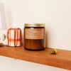 Brown jar of PF Candle Spiced Pumpkin on a wood shelf