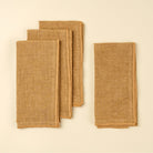 Stonewash Clay Linen Napkins, Set of 4 on a beige background at Addison West