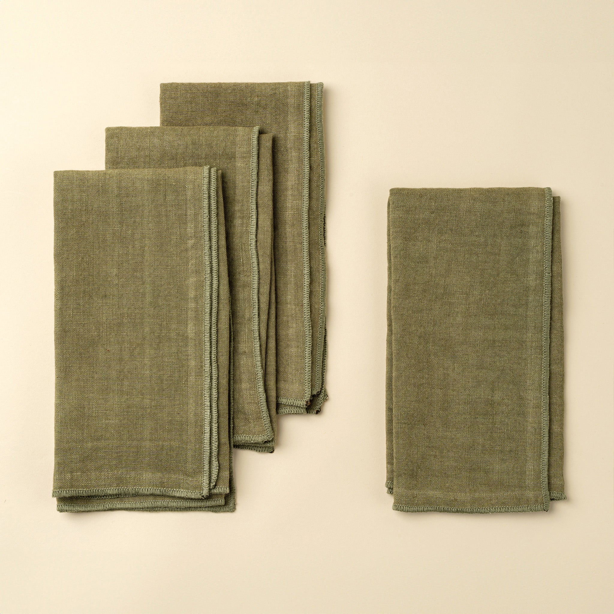 Stonewash Forest Linen Napkins, Set of 4 on a beige background at Addison West