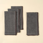 Stonewash Slate Linen Napkins, Set of 4 on a beige background at Addison West