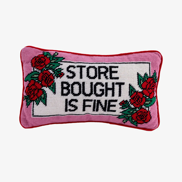Small needlepoint pillow by Furbish that says 'store bought is fine' on a white background