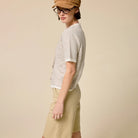 Striped Short Sleeve Button Cardigan in Taupe shown on model on plain background.