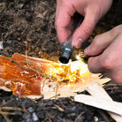 Person using the Survival Fire Starter to start a fire at Addison West
