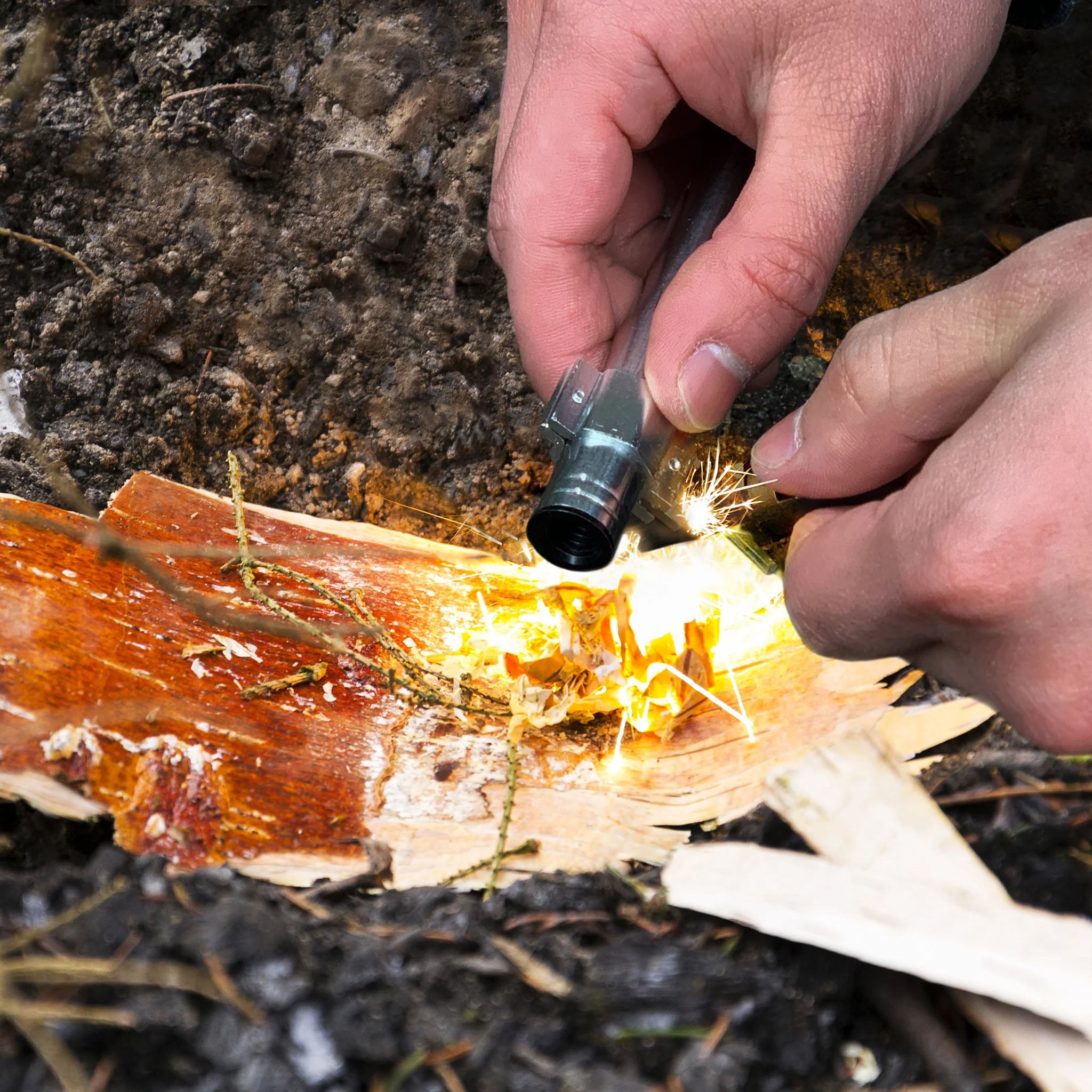 Person using the Survival Fire Starter to start a fire at Addison West
