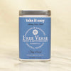 Metal Tin with blue label of Free Verse apothecary take it easy Loose Leaf Herbal Tea Blend on a beige background