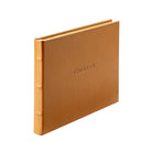 Tan Leather Bound Guest Book on white background at Addison West.