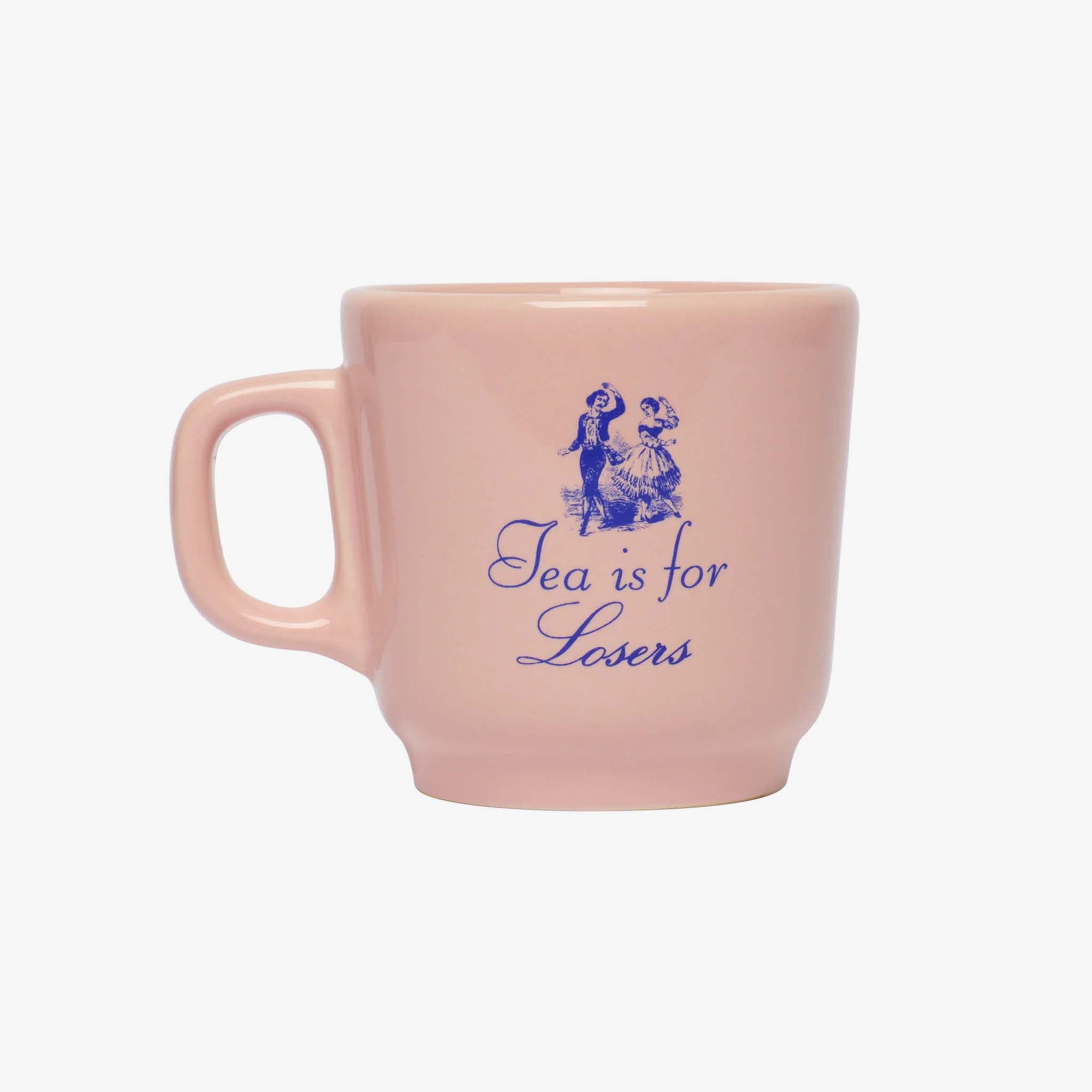 Pink mug with blue text and graphics on a white background