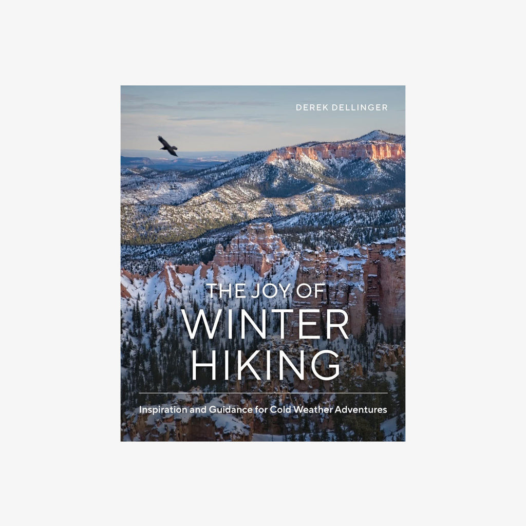 Book titled 'the joy of winter hiking' with snowy mountains on a white background