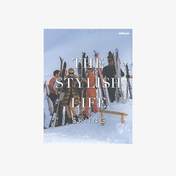 Front cover of book titled 'the stylish life skiing' showing skiers on a mountain on a white background