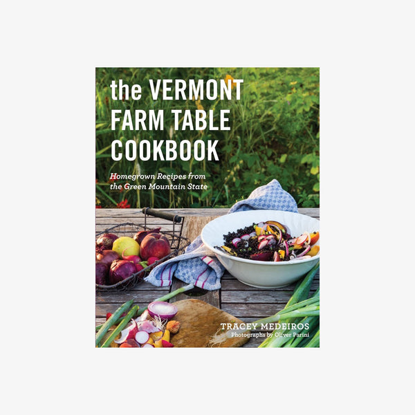 Front cover of 'The vermont farm table cookbook' with bowls of food on a wood table outside