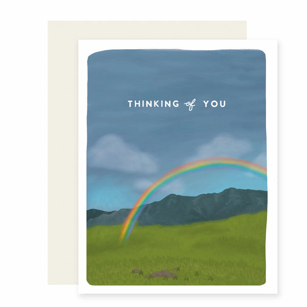 Thinking of You greeting card with illustration of field and mountains and rainbow on a white background