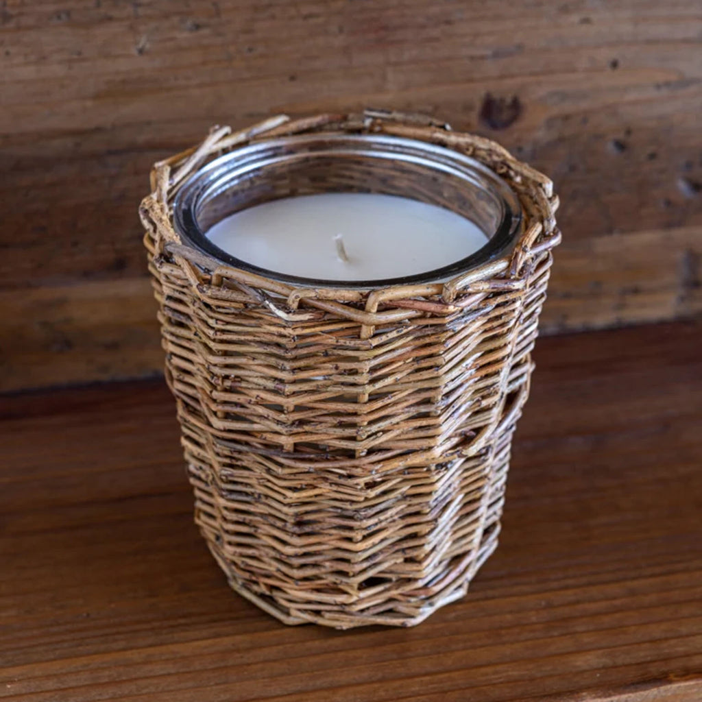 Porch View Home brand Tillage scented candle in willow wrapped vessel on a wood surface