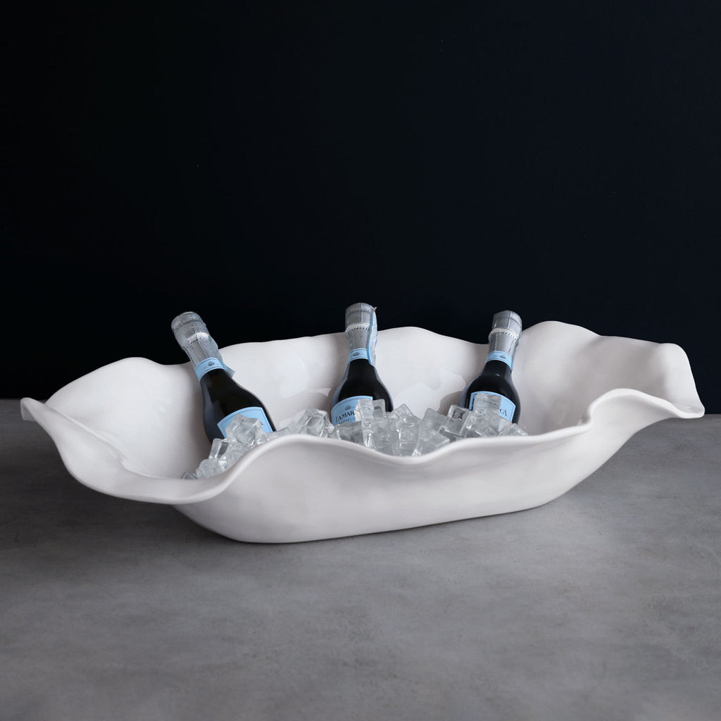 Beatriz Ball Vida Oval Centerpiece with champagne and ice on a stone surface