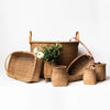 Collection of hand made in vermont rattan baskets on a white background