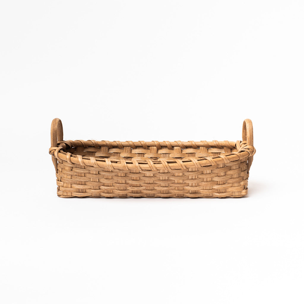 Vermont made rattan bread basket on a white background