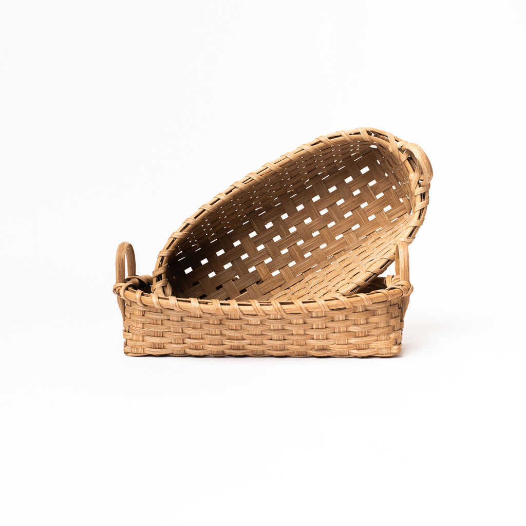 Two rattan bread baskets handmade in vermont on a white background