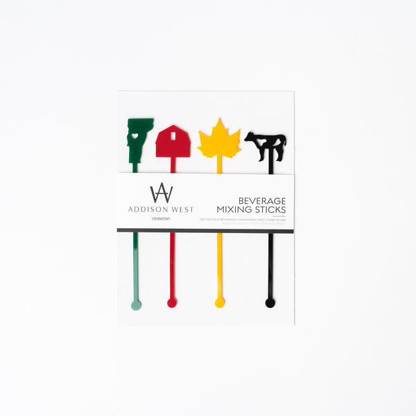Acrylic drink stirrers in vermont state theme with green state red barn gold leaf and black cow on a white background