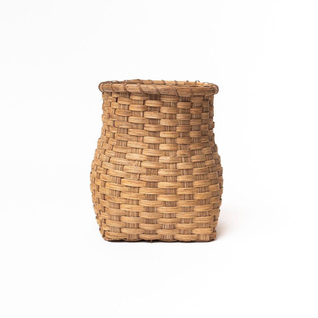 Handmade in Vermont rattan flower vase on a white background