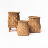 Collection of three hand woven rattan flower vases made in Vermont on a white background