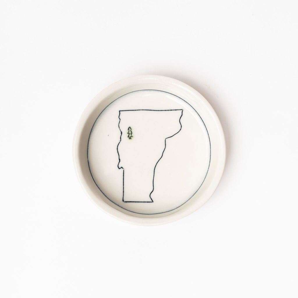 Small white handmade dish with drawing of state of vermont on a white background