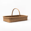 Hand Made in Vermont rattan harvest basket with handle on a white background