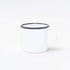 White enamel mug with black trim on white background.