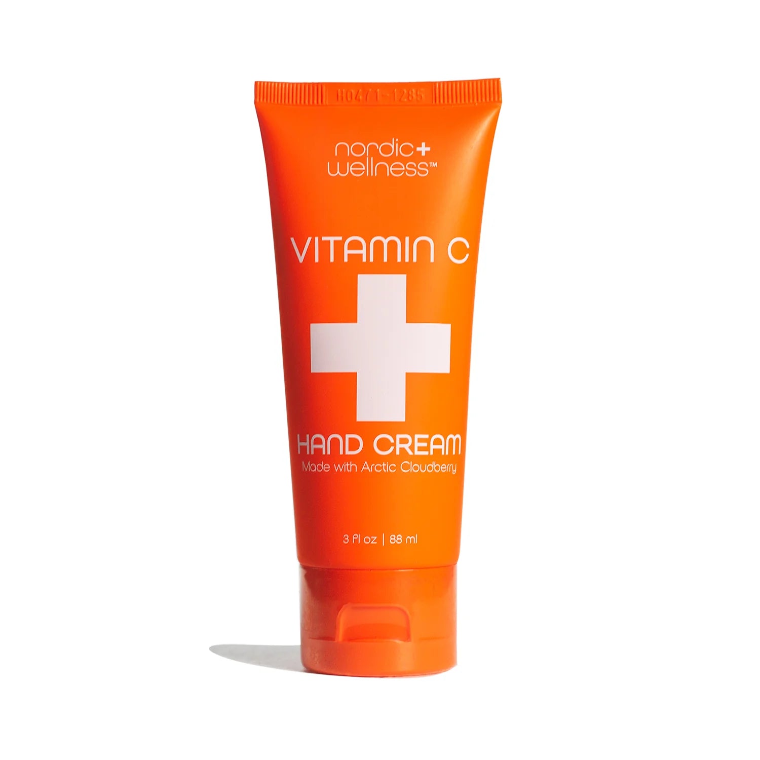 Orange tube of nordic wellness Vitamin C Hand Cream on a white background