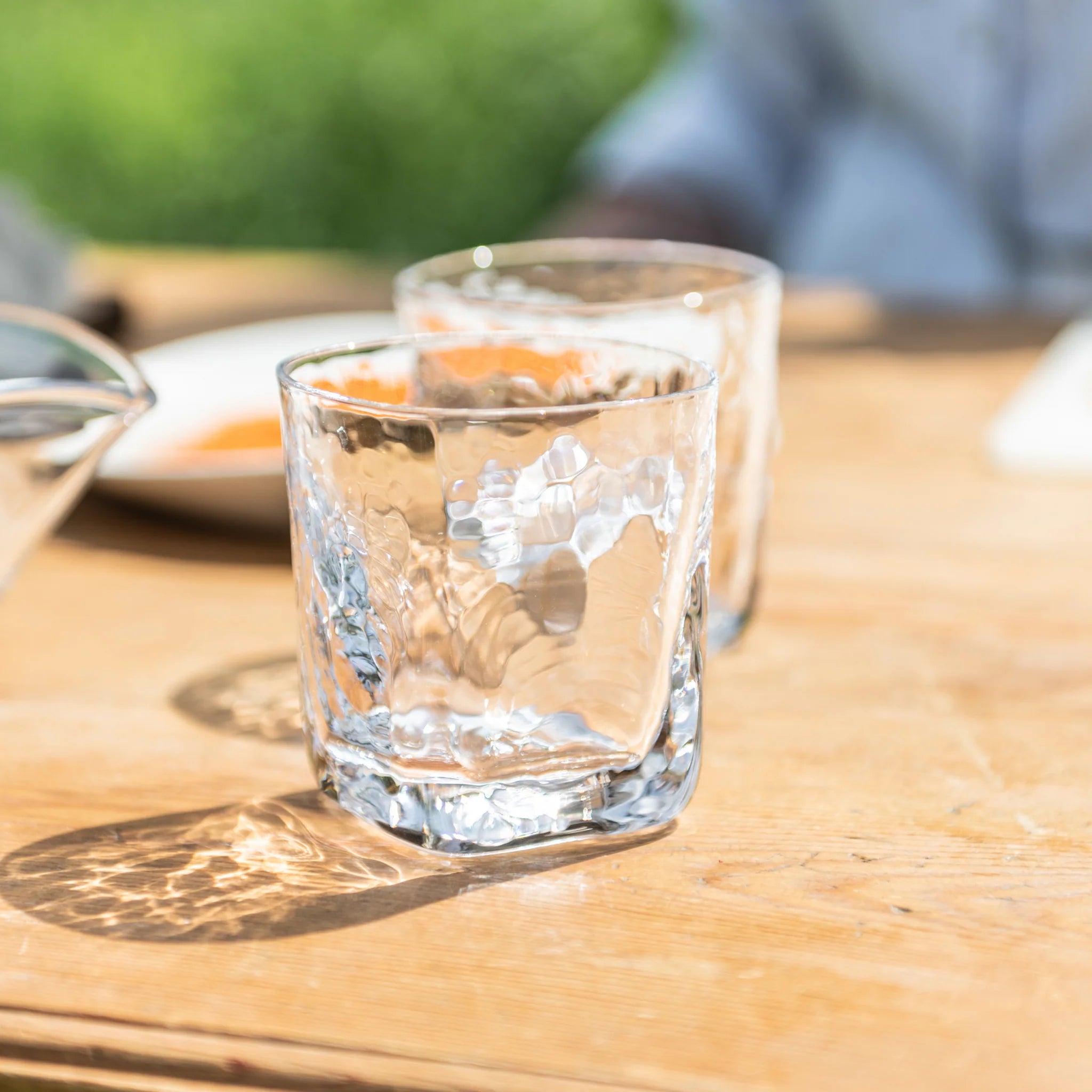 Woodbury Double Old-Fashioned Glass, Set of 2 on a wood table outside at Addison West